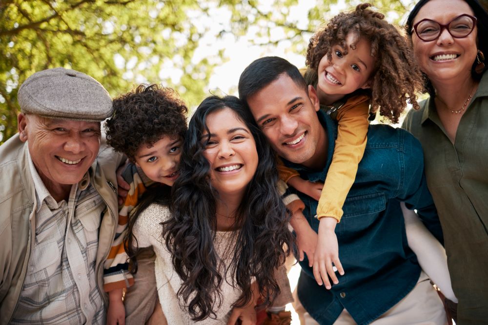 Intergenerational family smiling at a camera